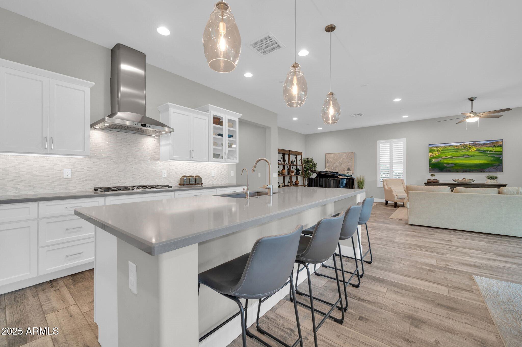 17565 Blaze Lane Rio Verde, AZ 85263 - Photo 11 of 43 a kitchen with stainless steel appliances kitchen island granite countertop a sink and cabinets