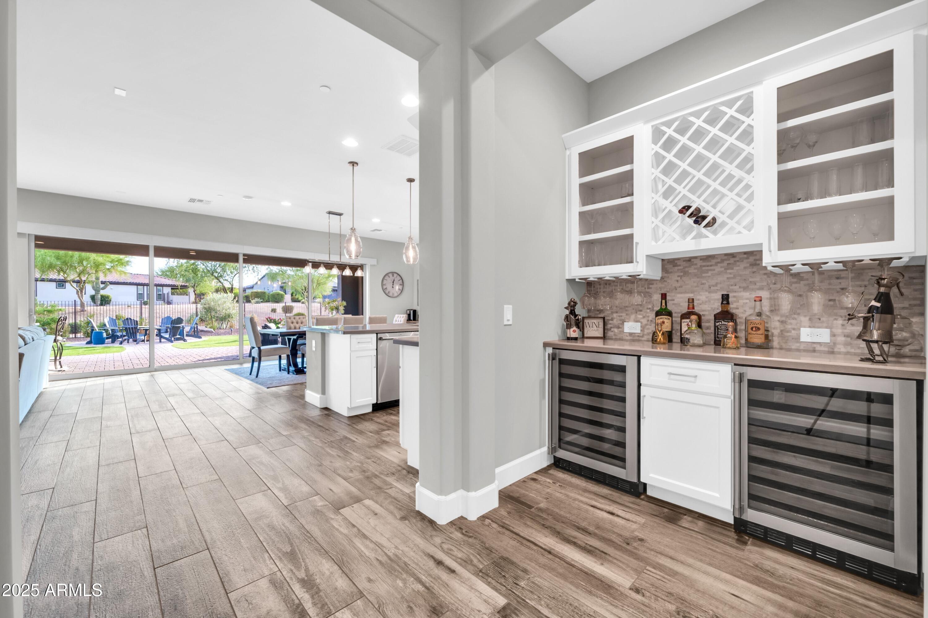 17565 Blaze Lane Rio Verde, AZ 85263 - Photo 13 of 43 a kitchen with stainless steel appliances a stove a sink and white cabinets with wooden floor