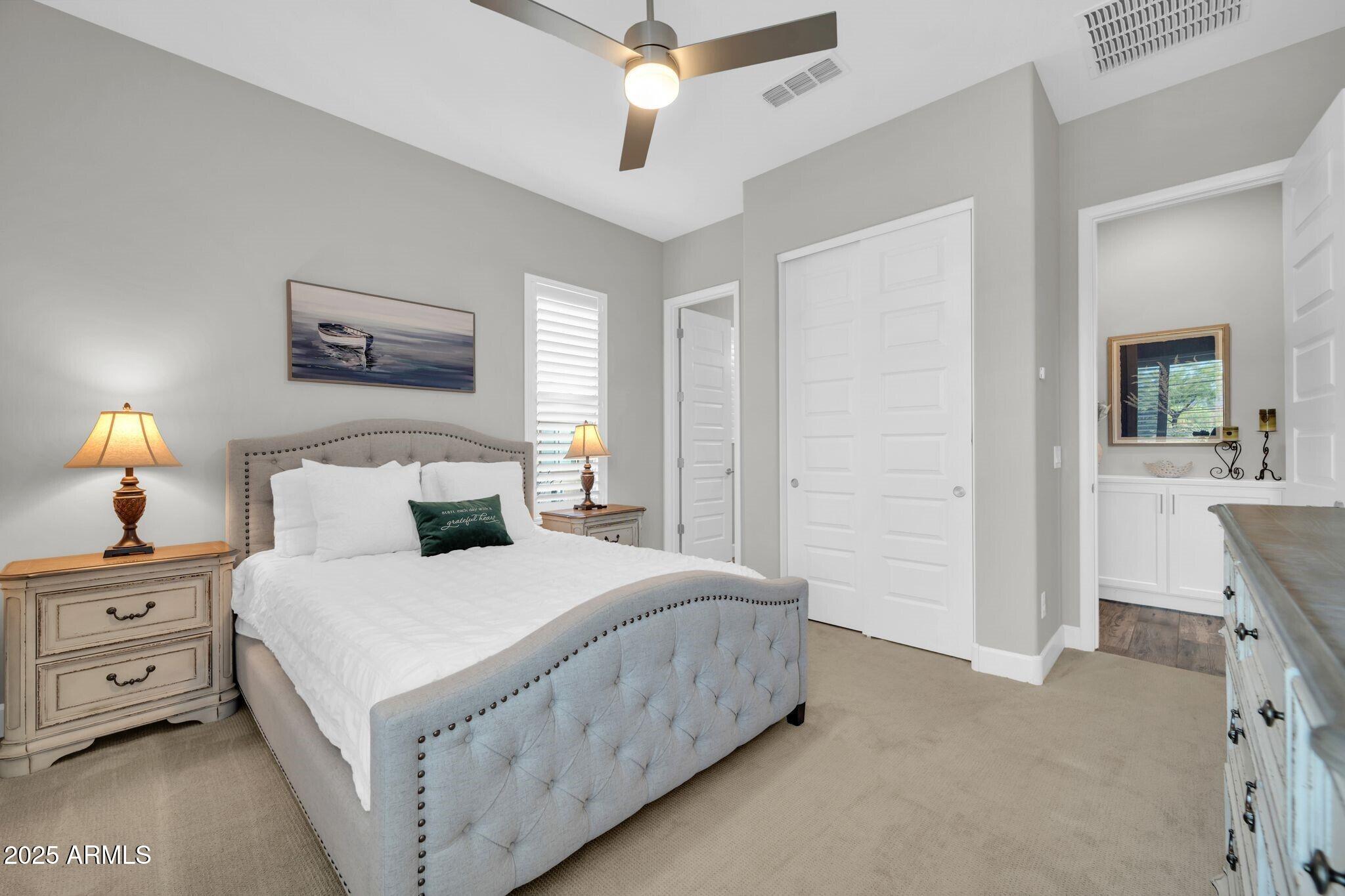 17565 Blaze Lane Rio Verde, AZ 85263 - Photo 19 of 43 a bedroom with a bed and a chandelier