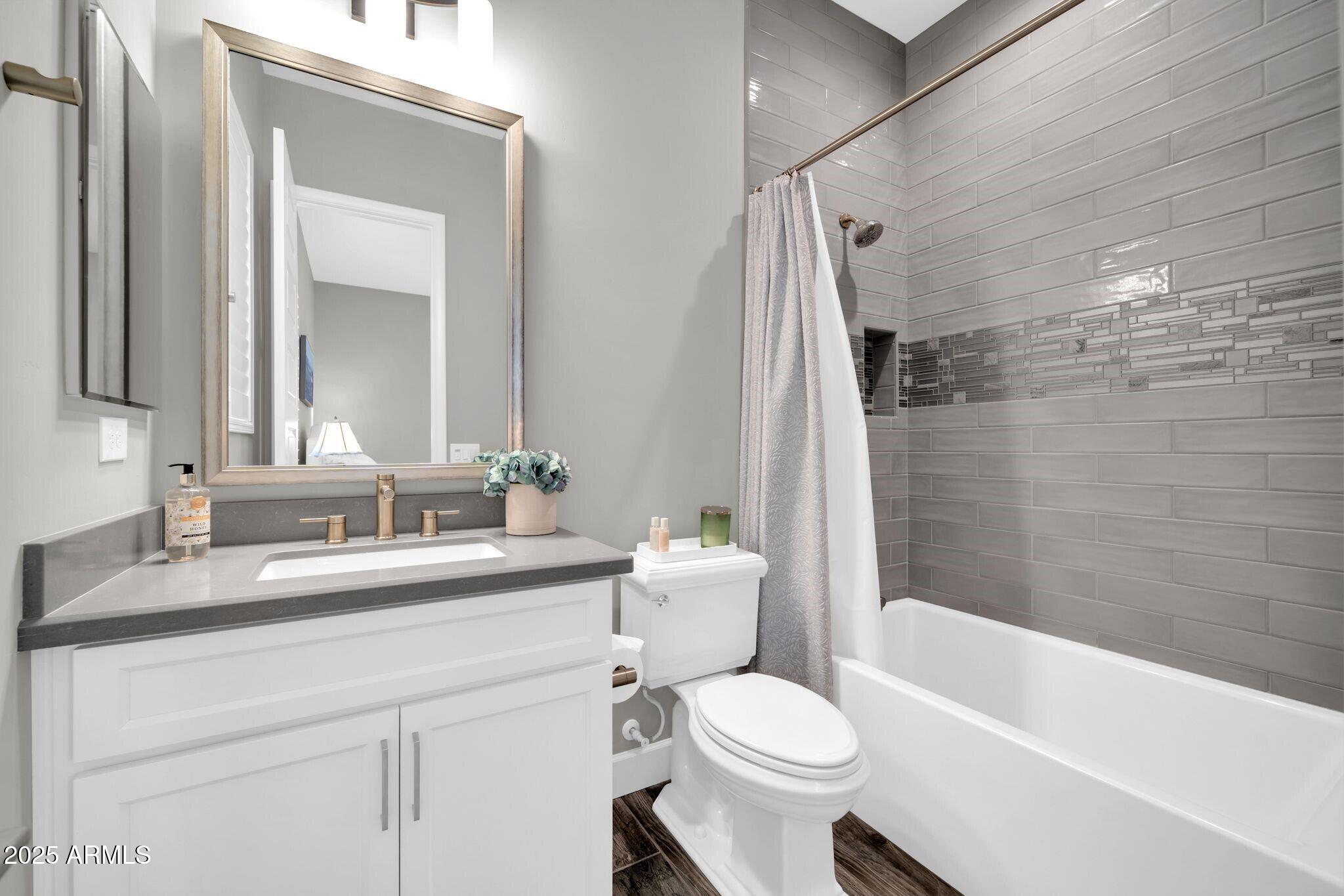 17565 Blaze Lane Rio Verde, AZ 85263 - Photo 20 of 43 a bathroom with a sink a toilet a mirror a bathtub and shower