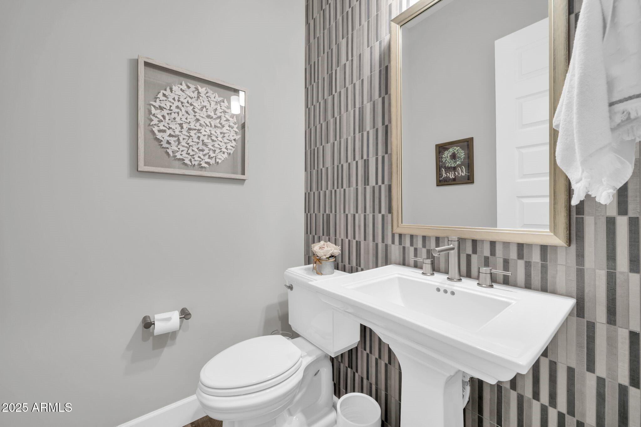 17565 Blaze Lane Rio Verde, AZ 85263 - Photo 24 of 43 a bathroom with a toilet a sink and a mirror