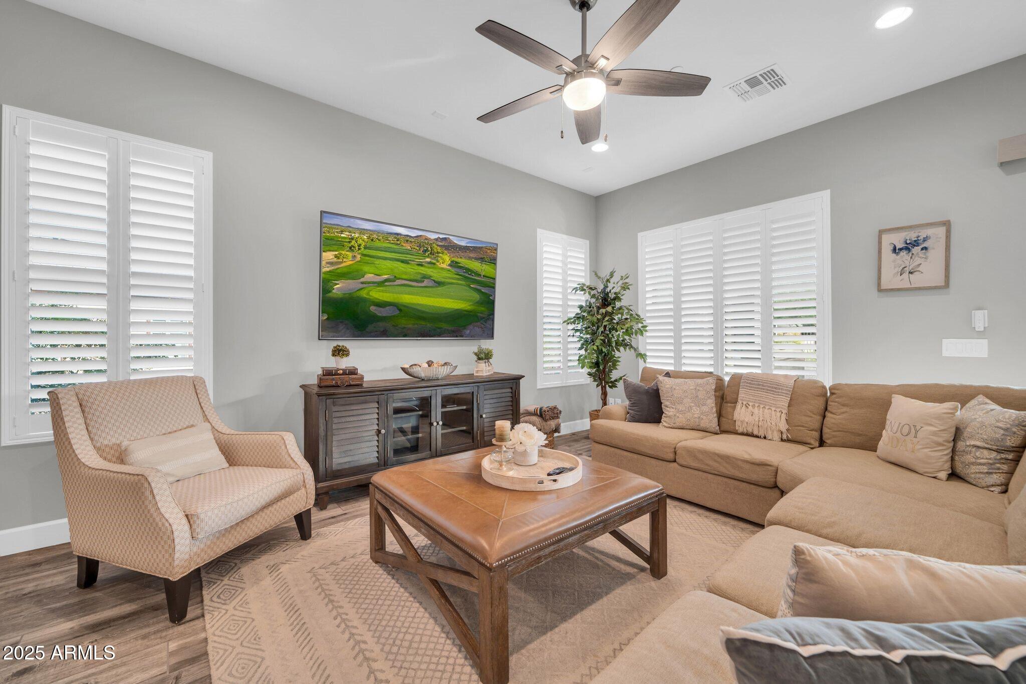 17565 Blaze Lane Rio Verde, AZ 85263 - Photo 6 of 43 a living room with furniture a large window and a flat screen tv