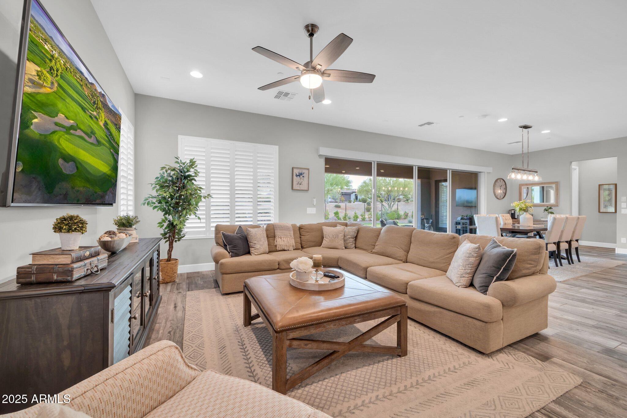 17565 Blaze Lane Rio Verde, AZ 85263 - Photo 7 of 43 a living room with furniture a flat screen tv and a large window