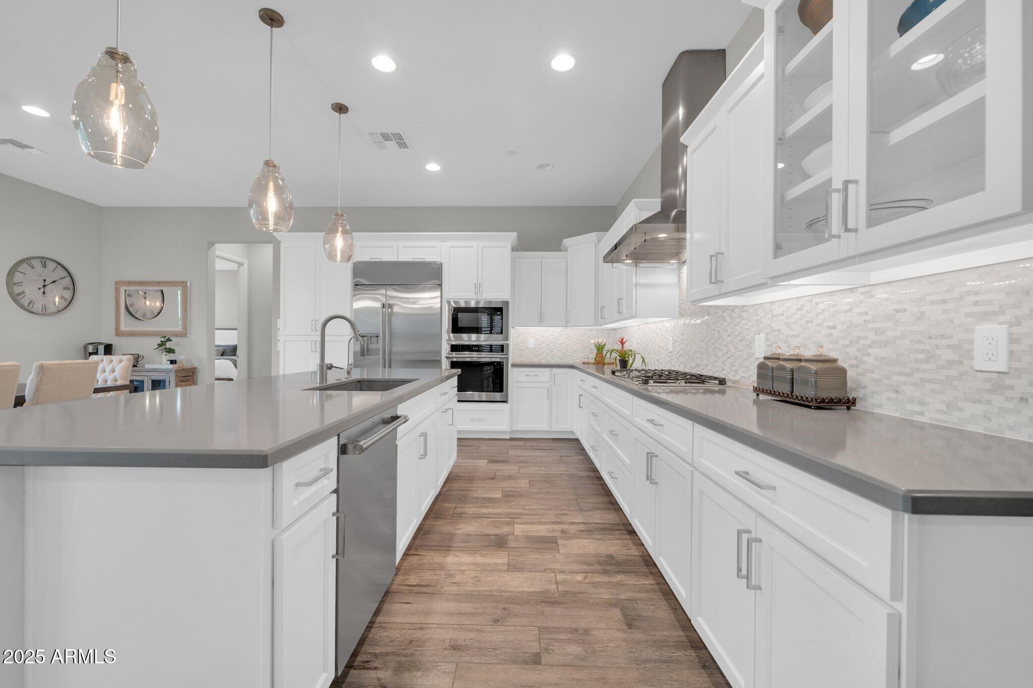 17565 Blaze Lane Rio Verde, AZ 85263 - Photo 9 of 43 a large white kitchen with lots of counter space and a sink