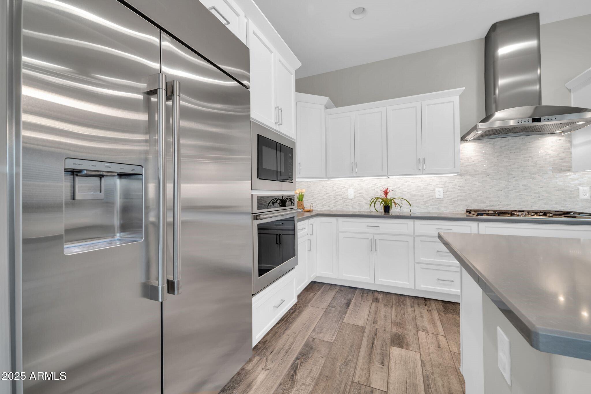 17565 Blaze Lane Rio Verde, AZ 85263 - Photo 10 of 43 a kitchen with kitchen island a counter top space cabinets and stainless steel appliances