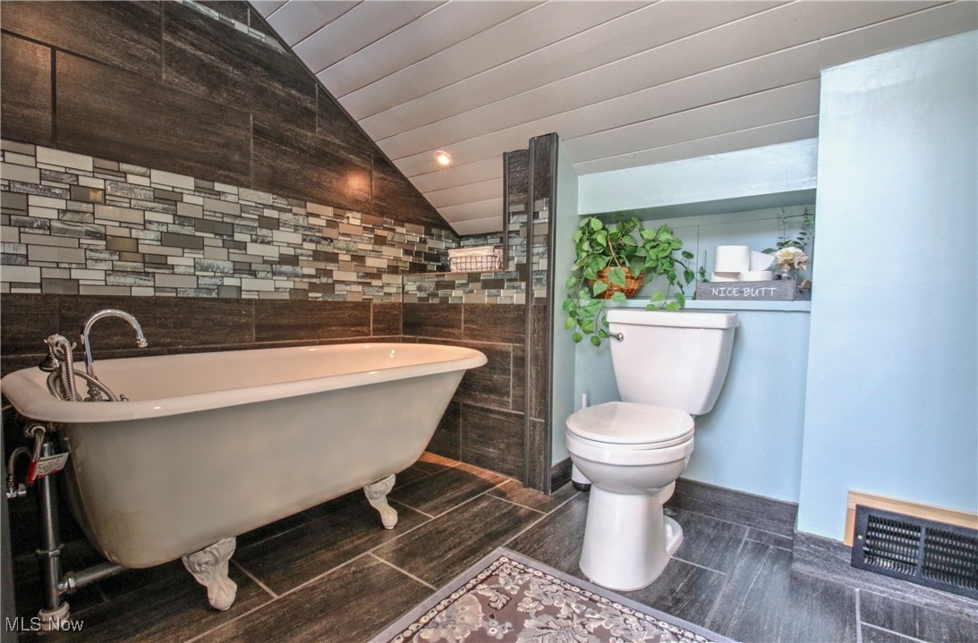 11375 Bean Road Chardon, OH 44024 - Photo 33 of 50 Full bath with a soaking tub, vaulted ceiling, tile walls, and recessed lighting