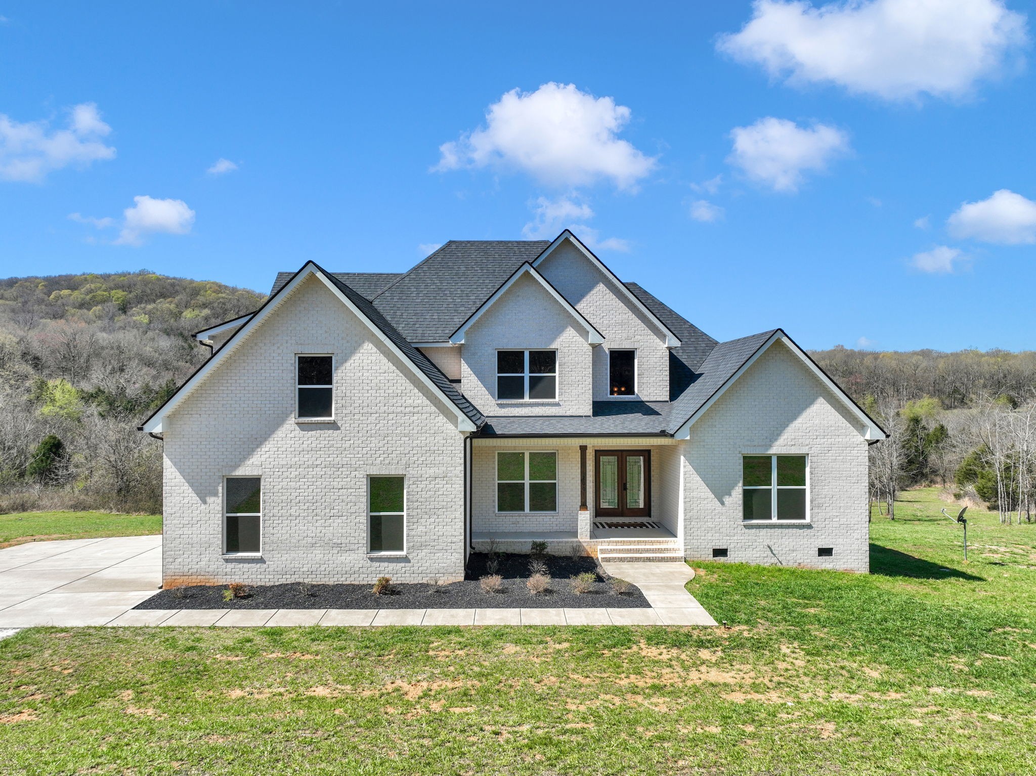 a front view of a house with a yard