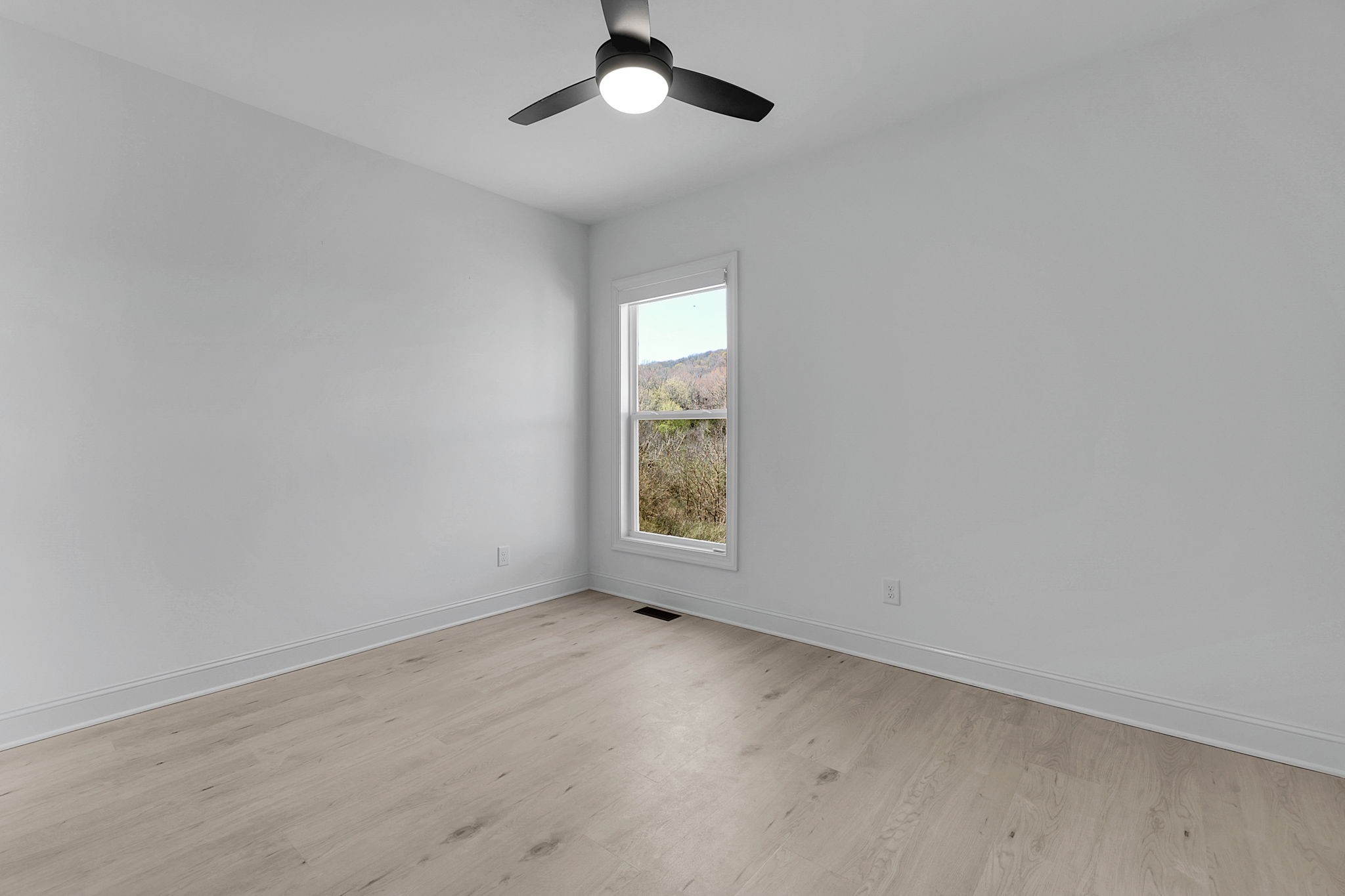 200 Charles Smith Road Lascassas, TN 37085 - Photo 41 of 62 an empty room with a window and a ceiling fan