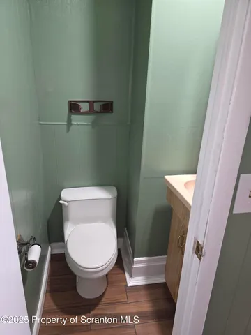 a white toilet sitting next to a small sink