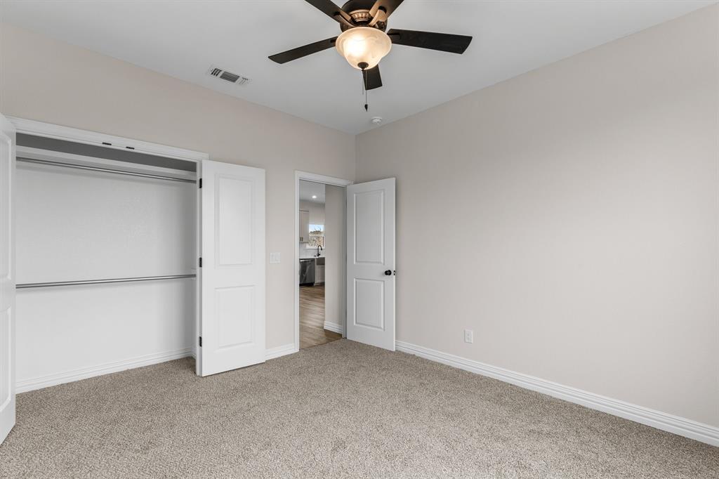 4695 Sisk Road Wichita Falls, TX 76310 - Photo 25 of 32 Unfurnished bedroom featuring ceiling fan, a closet, and carpet