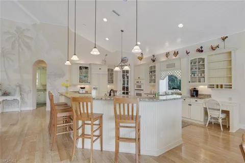 a large kitchen with a table and chairs