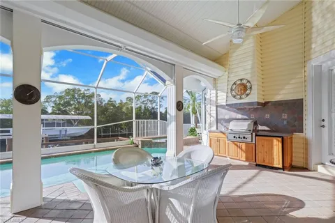 a dining room with furniture and a floor to ceiling window