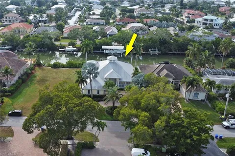 an aerial view of a house with a swimming pool outdoor seating and yard