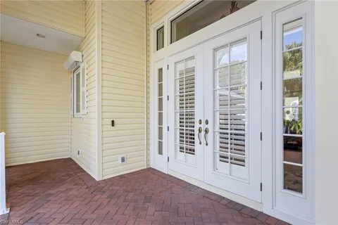 an entryway with wooden floor and windows