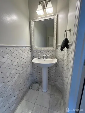a bathroom with a sink toilet and a mirror