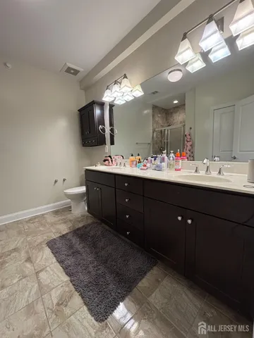 a bathroom with a sink vanity and toilet
