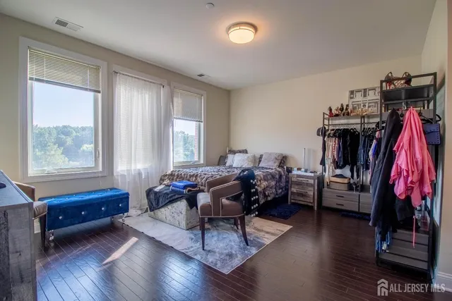 a bedroom with a bed and a view of walk in closet