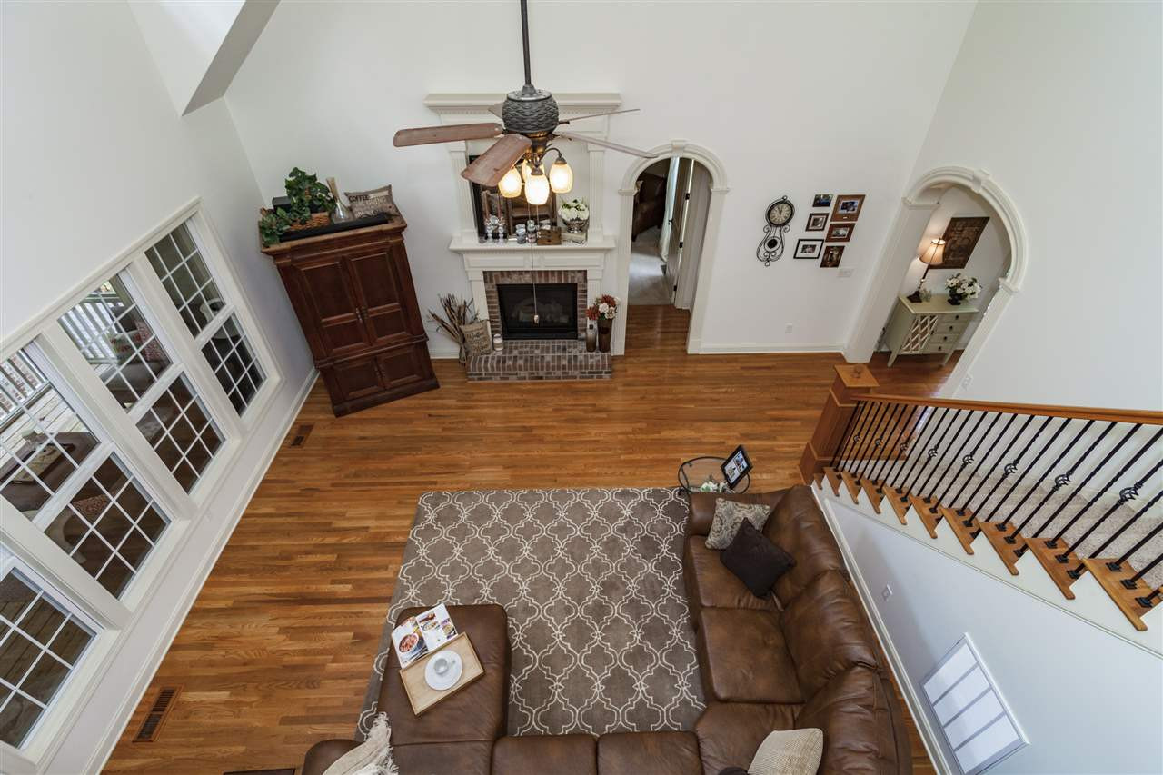 1700 Struble Circle Willow Spring, NC 27592 - Photo 20 of 25 Features vaulted two-story ceiling, ceiling fan, cut out window from kitchen, hardwood floors, Atrium windows, fireplace with custom moulding/trim, and many more appointed details. Den/Family/Great Room