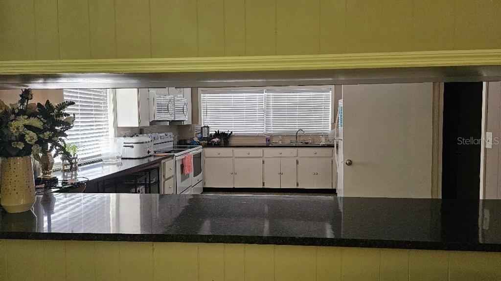 4600 98th Way North, Unit 210 St. Petersburg, FL 33708 - Photo 25 of 33 a kitchen with a sink and cabinets