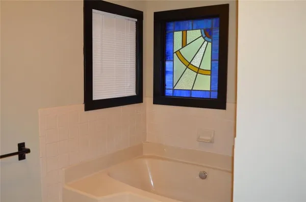 a bathroom with a bathtub and a shower
