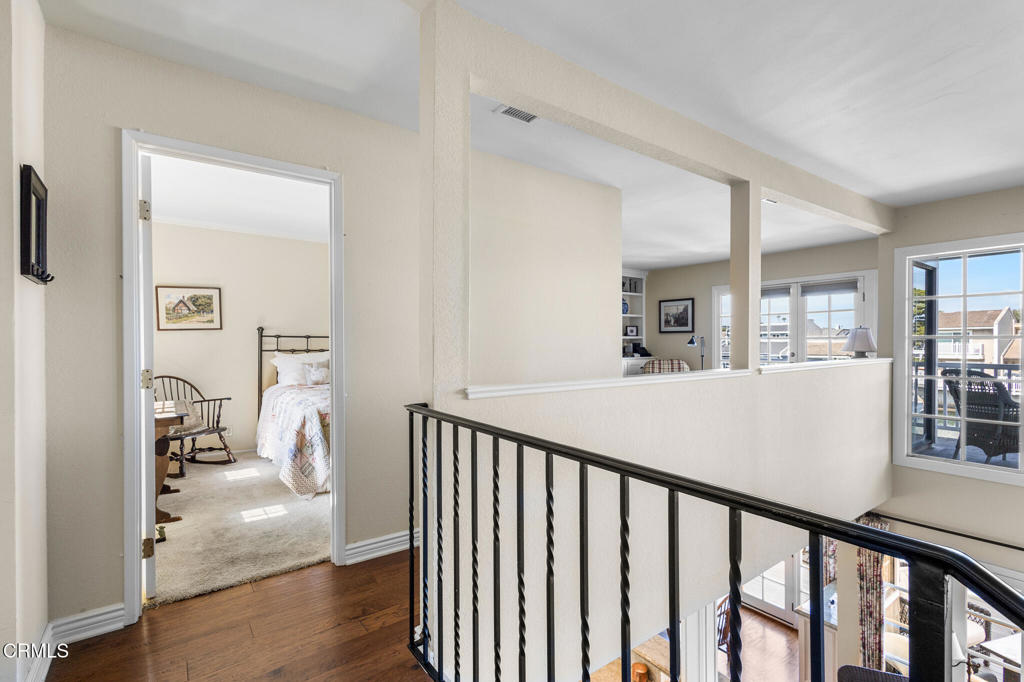 4505 Gateshead Bay Oxnard, CA 93035 - Photo 25 of 41 a view of a hallway with wooden floor and windows
