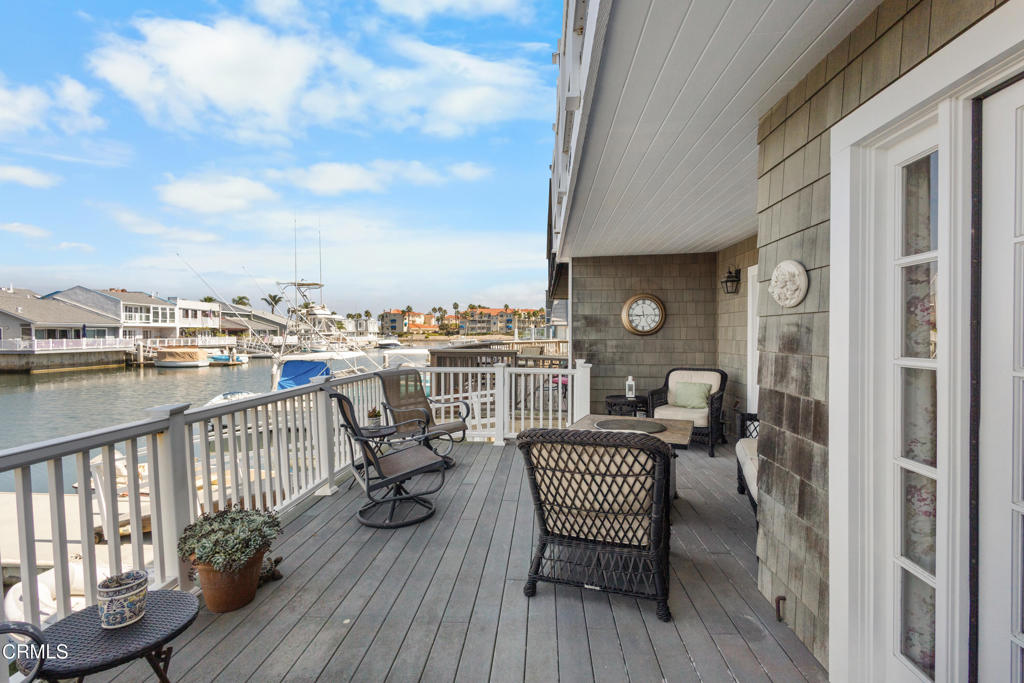 4505 Gateshead Bay Oxnard, CA 93035 - Photo 31 of 41 a view of a balcony with two chairs and wooden floor