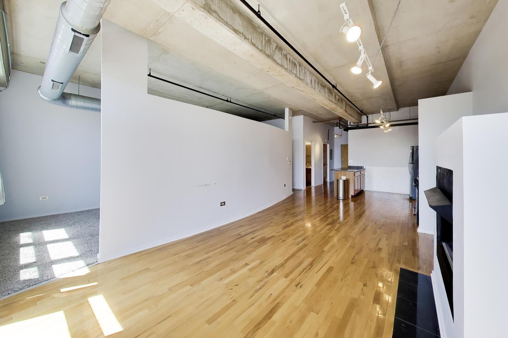 6 South Laflin Street, Unit 923 Chicago, IL 60607 - Photo 6 of 24 a view of a room with wooden floor