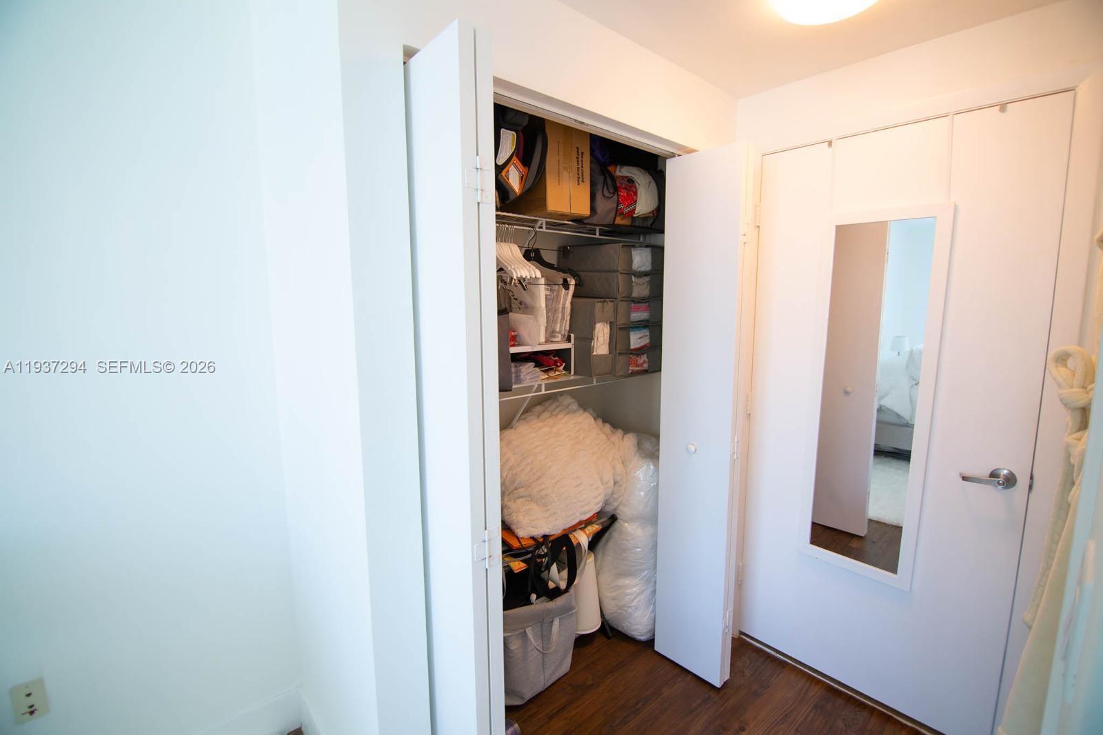 90 Southwest 3rd Street, Unit 2703 Miami, FL 33130 - Photo 11 of 28 a view of walk in closet with clothes and shoes