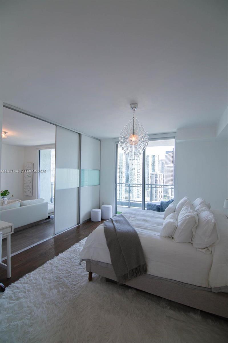 90 Southwest 3rd Street, Unit 2703 Miami, FL 33130 - Photo 13 of 28 a bedroom with a bed and window