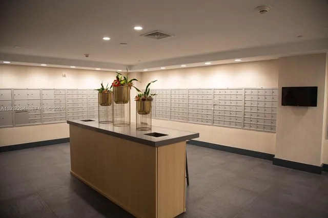 a kitchen with stainless steel appliances a sink and a wooden floor