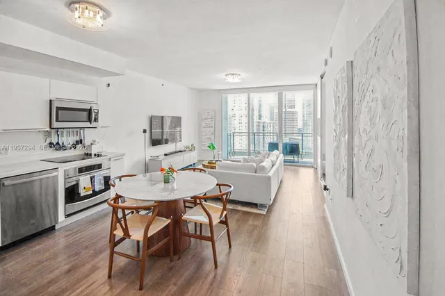 a view of a dining room with furniture and wooden floor