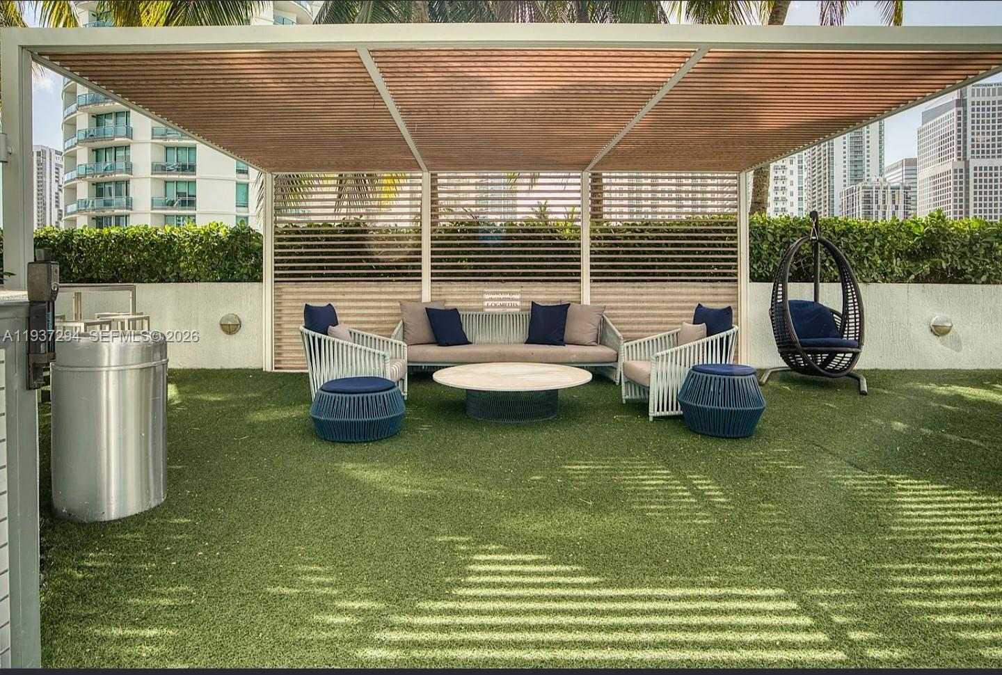 90 Southwest 3rd Street, Unit 2703 Miami, FL 33130 - Photo 23 of 28 a view of a patio with lawn chairs next to yard