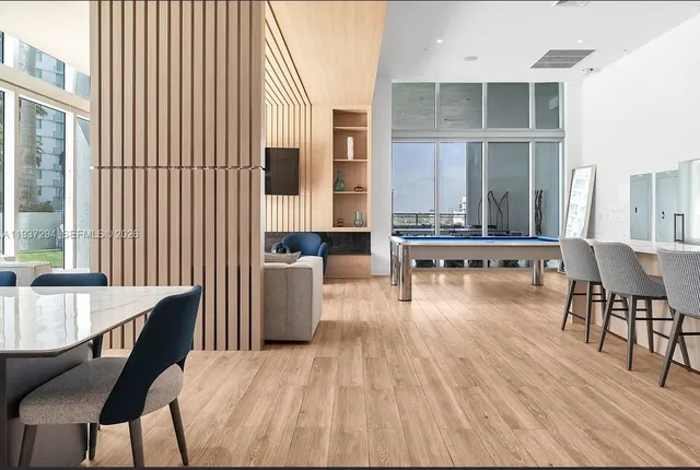 a dining room with furniture and wooden floor