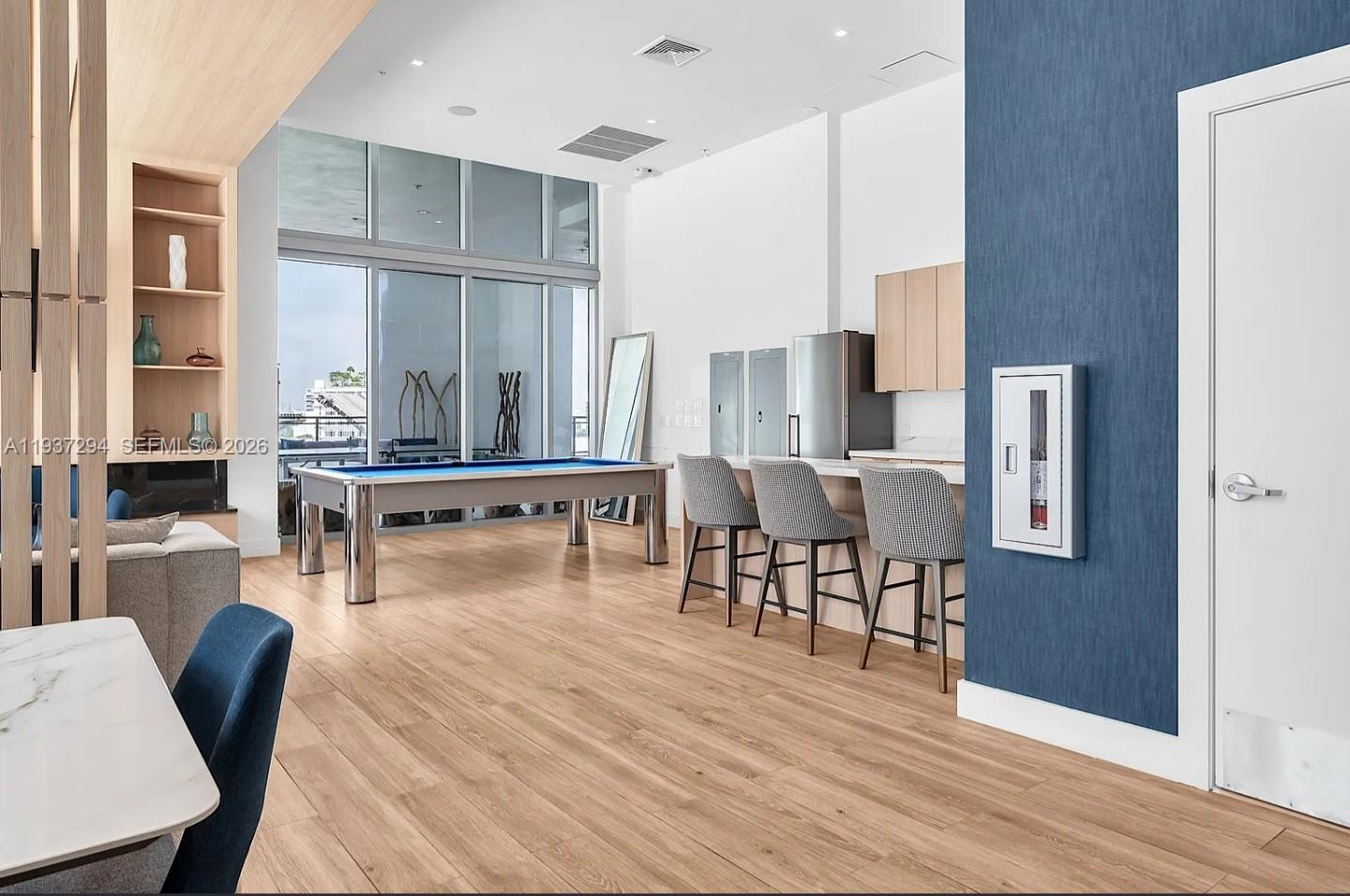 90 Southwest 3rd Street, Unit 2703 Miami, FL 33130 - Photo 26 of 28 a living room with furniture a wooden floor and a kitchen view