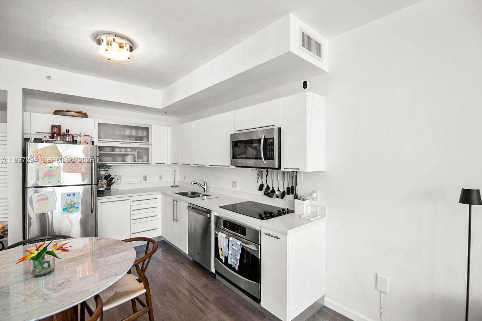 90 Southwest 3rd Street, Unit 2703 Miami, FL 33130 - Photo 3 of 28 a kitchen with a sink stove and refrigerator