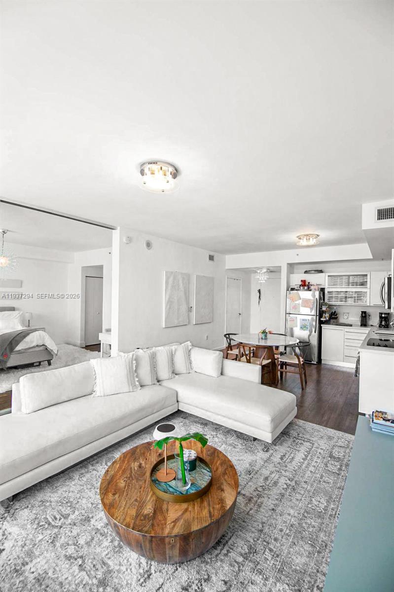 90 Southwest 3rd Street, Unit 2703 Miami, FL 33130 - Photo 5 of 28 a living room with furniture and a table