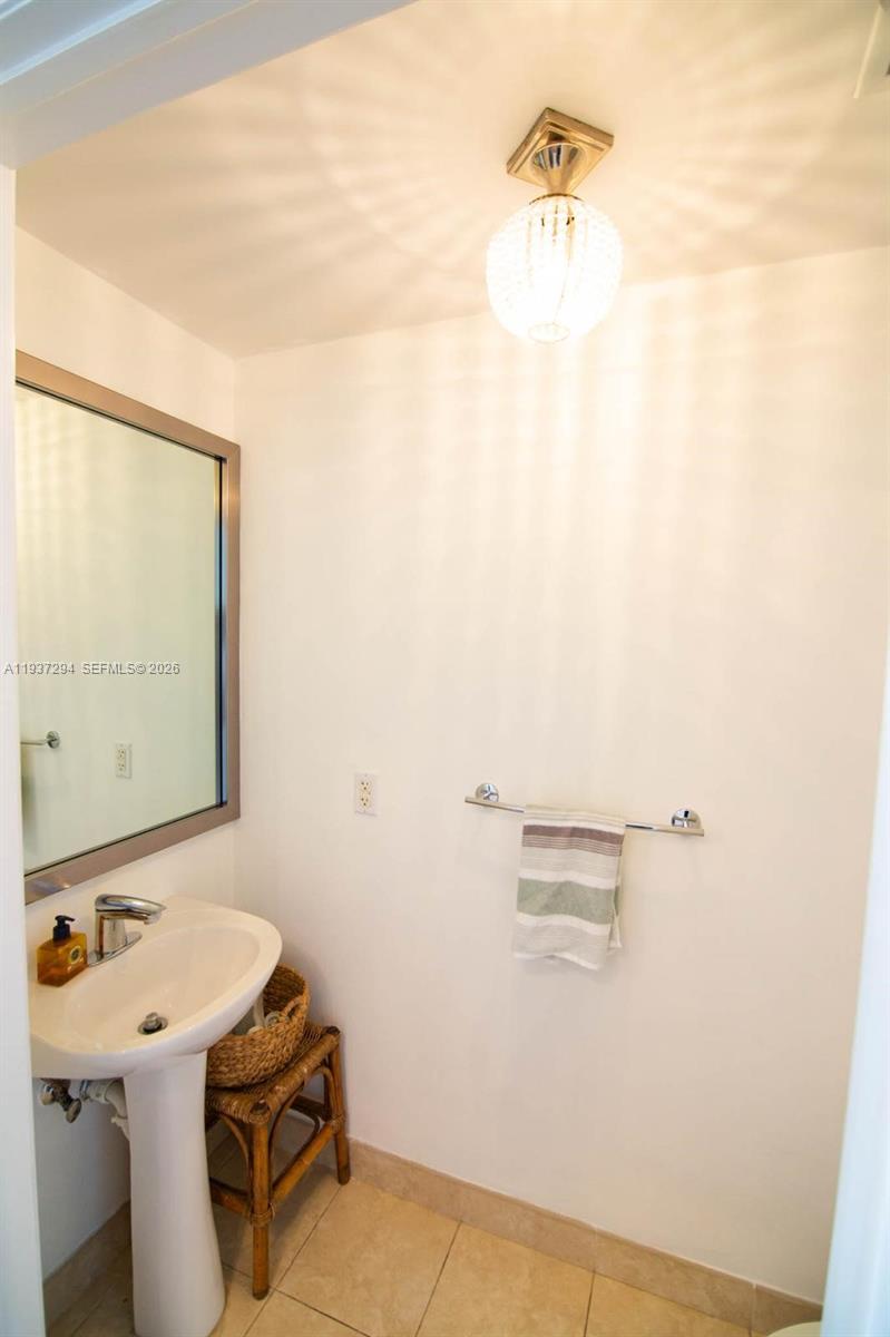 90 Southwest 3rd Street, Unit 2703 Miami, FL 33130 - Photo 8 of 28 a bathroom with a sink and a mirror