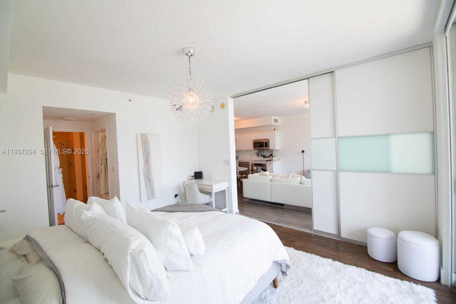 90 Southwest 3rd Street, Unit 2703 Miami, FL 33130 - Photo 9 of 28 a bedroom with a bed and a couch