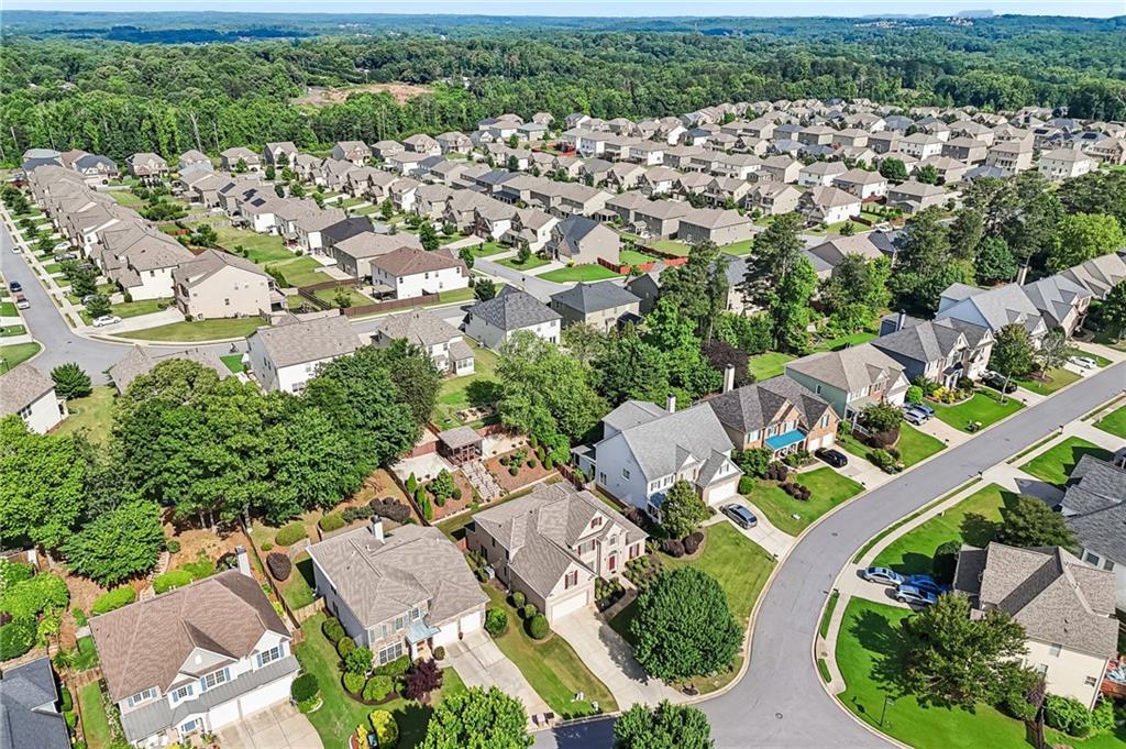 810 Freedom Way Cumming, GA 30040 - Photo 57 of 61 an aerial view of residential houses with outdoor space and trees