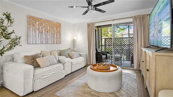 a living room with furniture and a floor to ceiling window