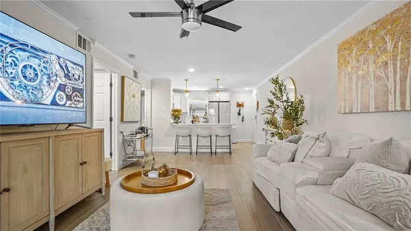 a living room with furniture and a wooden floor