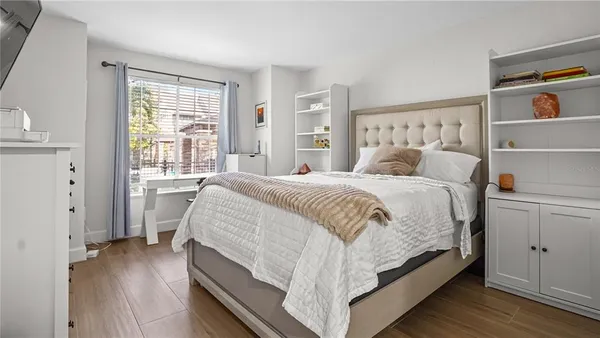 a bedroom with a bed and a window