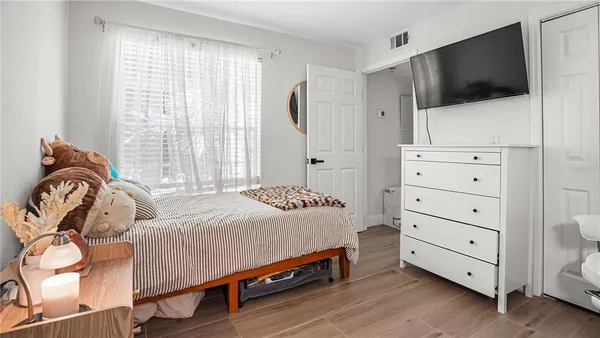 a bedroom with a bed and flat screen tv