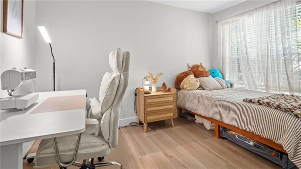 a bedroom with a bed and wooden floor