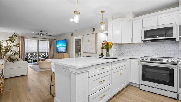 a kitchen with a stove a sink and a refrigerator