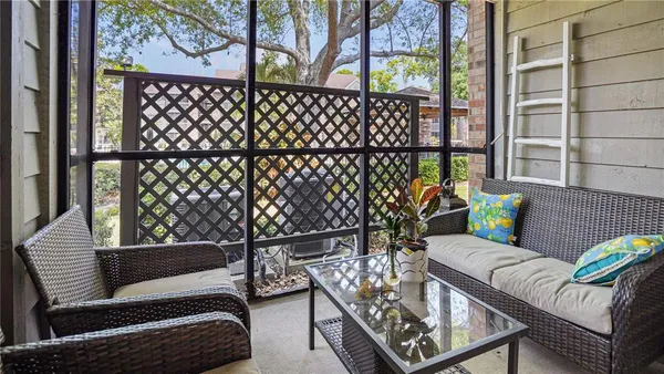 a view of a chairs and table in the balcony