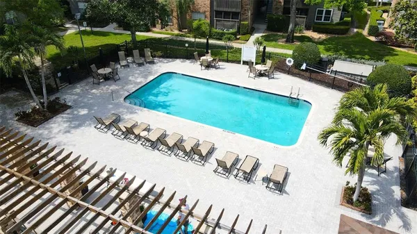 swimming pool view with a seating space