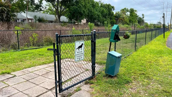a view of a park with iron fence