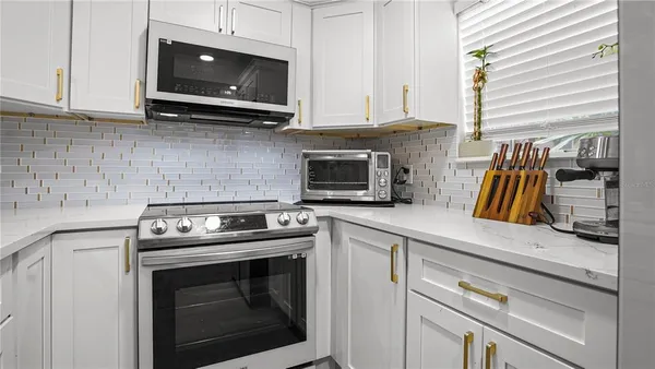 a kitchen with a stove and a microwave