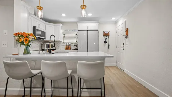 a dining table chairs and a refrigerator